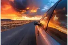 Car driving into the sunset